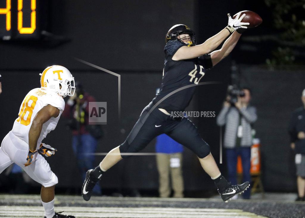Mark Humphrey Vanderbilt tight end Cody Markel (45) catches a 2-yard touchdown pass ahead of Tennessee defensive back Nigel Warrior (18) in the second half of an NCAA college football game Saturday, Nov. 24, 2018, in Nashville, Tenn. (AP Photo/Mark Humphrey)