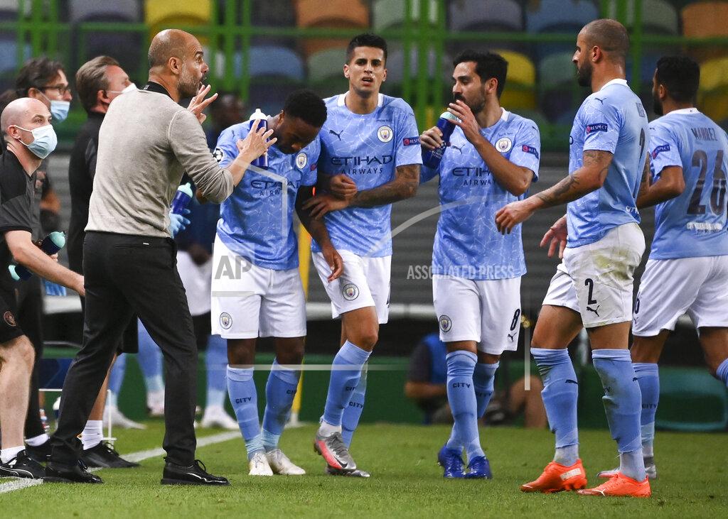 Franck Fife Manchester City's head coach Pep Guardiola talks to his players during the Champions League quarterfinal match between Manchester City and Lyon at the Jose Alvalade stadium in Lisbon, Portugal, Saturday, Aug. 15, 2020. (Franck Fife/Pool Photo via AP)