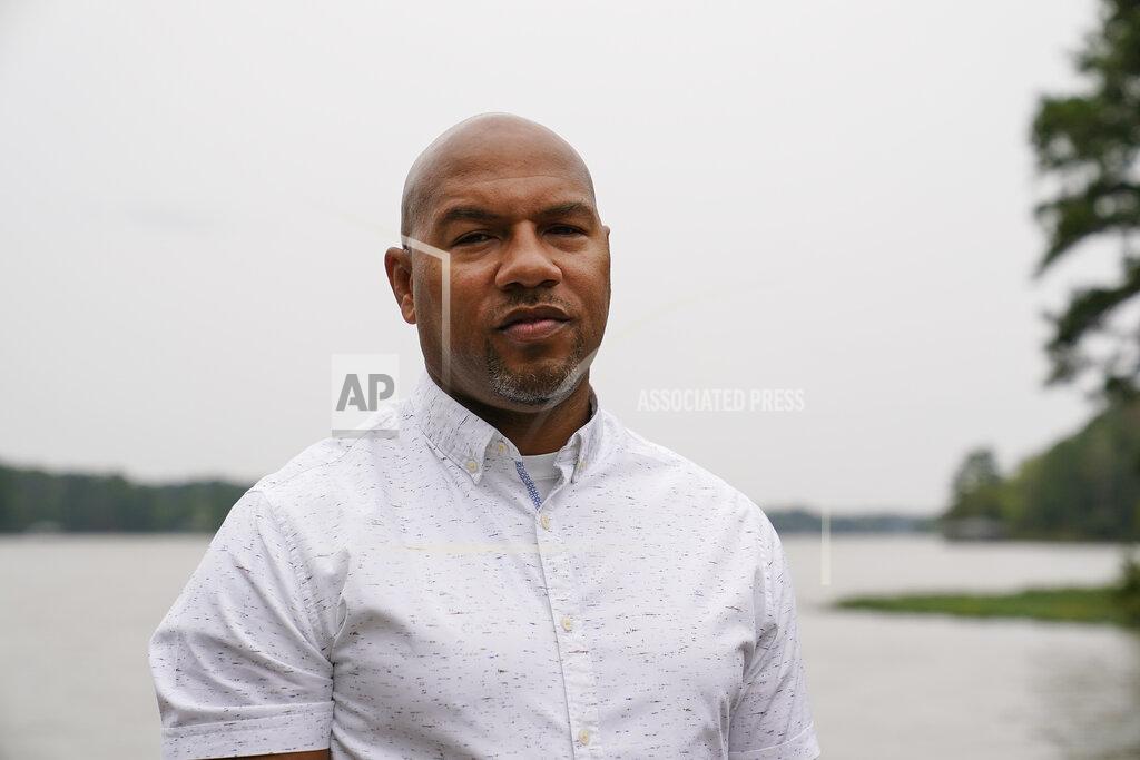 Brynn Anderson Hancock County coroner Adrick Ingram, 44, of Sparta, poses for a portrait on a deck next to a lake, Saturday, Sept. 19, 2020, in Sparta, Ga. The number of COVID-19 deaths in Hancock County is the highest per-capita rate of any U.S. county. ''It has affected our community in a way that I consider tragic," Ingram says. (AP Photo/Brynn Anderson)