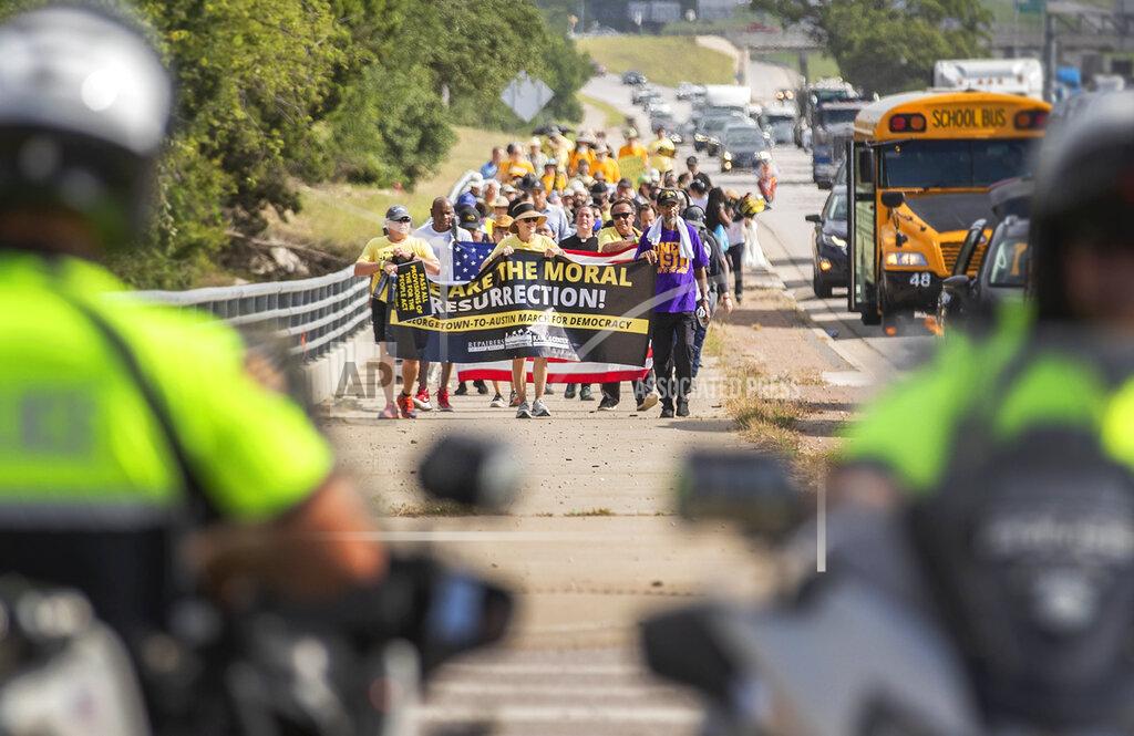 Ricardo B. Brazziell A group of people make a stop at Good Hope Church in Round Rock, Texas, Wednesday, July 28, 2021 during a march from Georgetown, Texas to the Texas State Capitol in downtown Austin. Church leaders and former Democratic congressman Beto O'Rourke are leading the nearly 30-mile voting rights march in Texas. The walk began with nearly 100 participants in suburban Austin and will is scheduled to end this weekend at the state Capitol. The march is the latest effort by Democrats to keep up the pressure over voting rights at a time when the prospects of action from Congress is fading. (Ricardo B. Brazziell/Austin American-Statesman via AP)