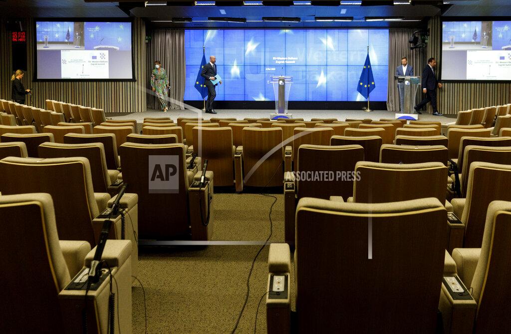 Olivier Matthys European Council President Charles Michel, center, arrives for a media conference after an EU-Western Balkans videoconference summit at the EU Council building in Brussels, Wednesday, May 6, 2020. European Union leaders sought Wednesday to reassure their counterparts from six Balkans countries that the bloc remains the volatile region's most important partner, particularly as the coronavirus hits their societies, ravaging health care systems and economies. (AP Photo/Olivier Matthys, Pool)