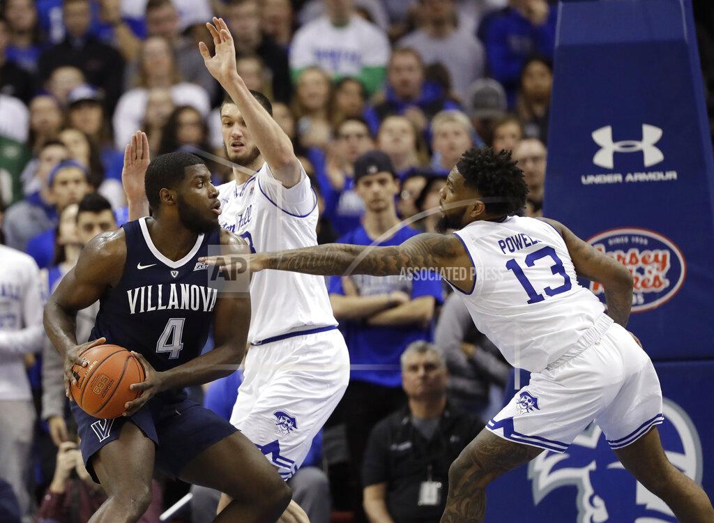 Kathy Willens Seton Hall guard Myles Powell (13) and forward Sandro Mamukelashvili, center, defend as Villanova forward Eric Paschall (4) looks to make a move during the second half of an NCAA college basketball game, Saturday, March 9, 2019, in Newark, N.J. Seton Hall defeated Villanova 79-75. (AP Photo/Kathy Willens)