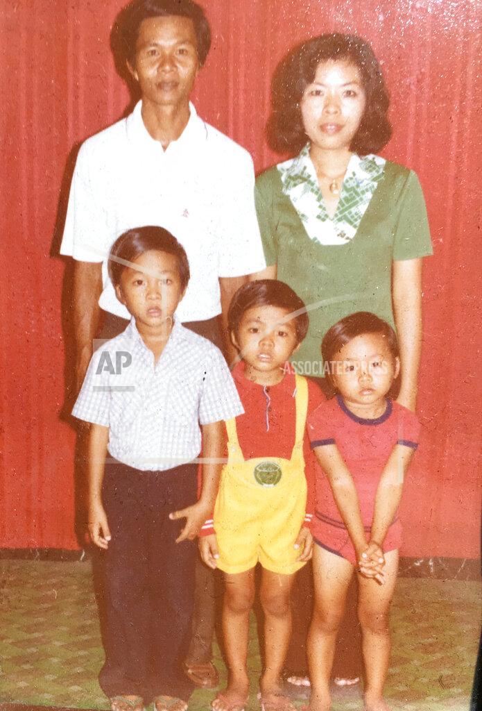 Uncredited In this image provided by Lo van Pham, Lo van Pham, front center, his parents and siblings pose for a photo before the family came to America. Lo van Pham’s journey to the NFL began when he fell in love with sports upon arriving in Texas after living in refugee camps with his family. More than 40 years later, van Pham is set to become the first Asian American to officiate in the NFL. (Lo van Pham/NFL via AP)