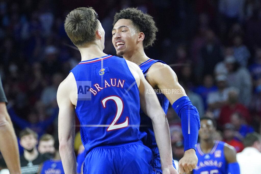 Sue Ogrocki Kansas forward Jalen Wilson, right, celebrates with teammate Christian Braun (2) in the second half of an NCAA college basketball game against Oklahoma, Tuesday, Jan. 18, 2022, in Norman, Okla. (AP Photo/Sue Ogrocki)