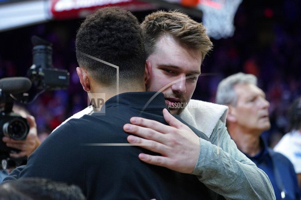 Matt York Dallas Mavericks guard Luka Doncic embraces Phoenix Suns guard Devin Booker, left, after Game 7 of an NBA basketball Western Conference playoff semifinal, Sunday, May 15, 2022, in Phoenix. The Mavericks defeated the Suns 123-90. (AP Photo/Matt York)