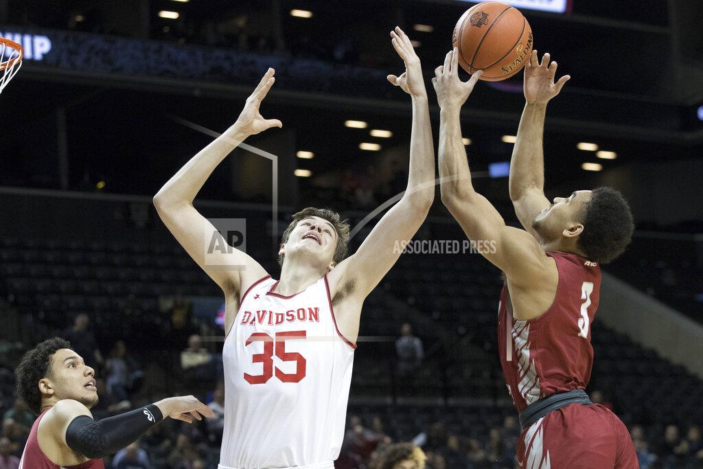 Mary Altaffer Davidson forward Luka Brajkovic (35) and Saint Joseph's guard Jared Bynum (3) vie for a rebound during the first half of an NCAA college basketball game in the Atlantic 10 Conference tournament, Friday, March 15, 2019, in New York. (AP Photo/Mary Altaffer)