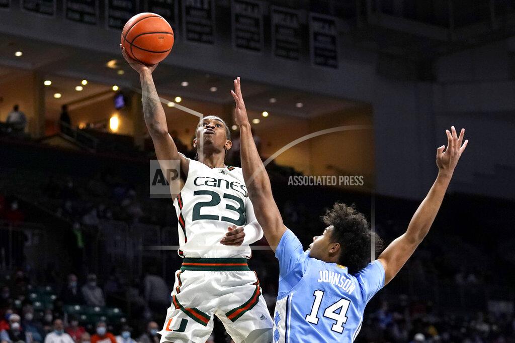 Lynne Sladky Miami guard Kameron McGusty (23) shoots over North Carolina guard Puff Johnson (14) during the second half of an NCAA college basketball game, Tuesday, Jan. 18, 2022, in Coral Gables, Fla. Miami won 85-57. (AP Photo/Lynne Sladky)