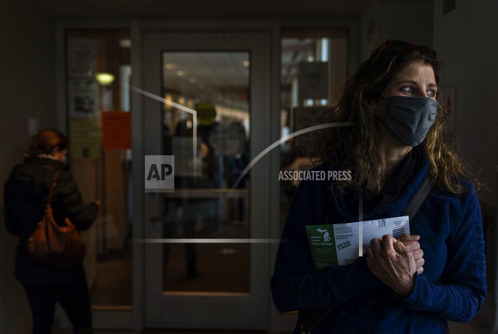 David Goldman Diane Spiteri clutches her absentee ballot before dropping it off at the city clerk's office in Warren, Mich., Wed, Oct. 28, 2020. "I just can't wait until the whole thing is over. And I think it's long from over, even after Tuesday. There's just so much anxiety," said Spiteri, who cast her ballot last week for Biden. As the traditional Election Day closes in, Americans are exhausted from constant crises, on edge because of volatile political divisions and anxious about what will happen next. (AP Photo/David Goldman)