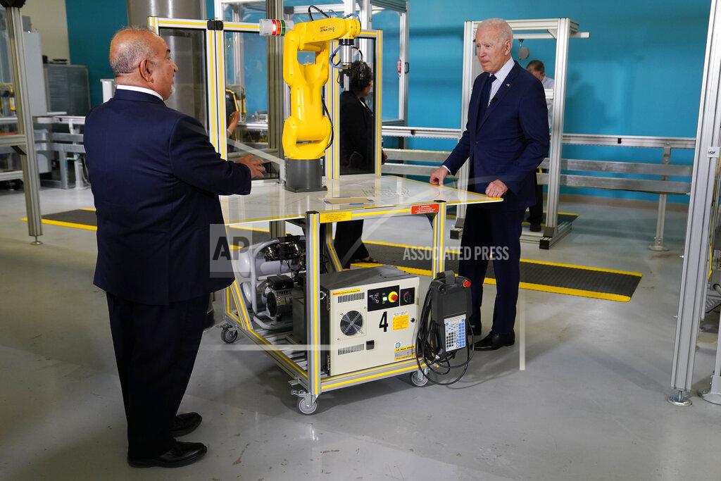 Evan Vucci President Joe Biden listens during a tour of the Cuyahoga Community College Manufacturing Technology Center, Thursday, May 27, 2021, in Cleveland. (AP Photo/Evan Vucci)
