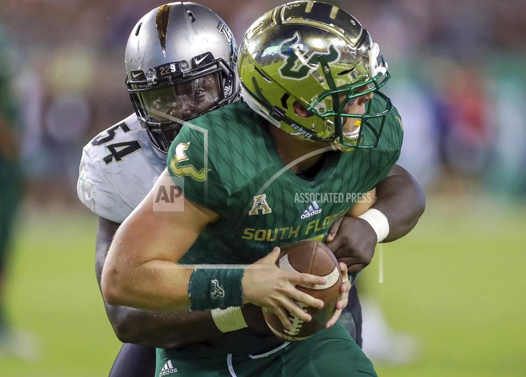 Mike Carlson Central Florida's A.J. Wooten (54) sacks South Florida quarterback Brett Kean during the second half of an NCAA college football game Friday, Nov. 23, 2018, in Tampa, Fla. (AP Photo/Mike Carlson)