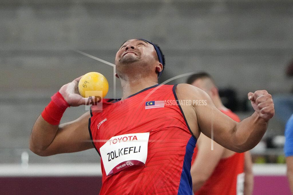 Eugene Hoshiko FILE - In this Tuesday, Aug. 31, 2021, file photo, Muhammad Ziyad Zolkefli of Malaysia competes in the men's shot put F20 final during the Tokyo 2020 Paralympics Games at the National Stadium in Tokyo. Zolkefli appeared to have won gold in the shot put in the F20 class. But after the victory on Tuesday, he was disqualified because he had shown up late for the competition. (AP Photo/Eugene Hoshiko, File)