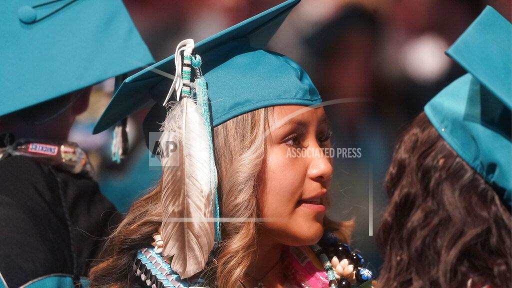 Rick Bowmer Brailyn Jake wears an eagle feather at her graduation from Cedar City High School Wednesday from Cedar City High School on Wednesday, May 25, 2022, in Cedar City, Utah. Last year, two school principals in southern Utah's Iron County School District attempted to bar two Native American students from wearing forms of tribal regalia at their graduation ceremonies. One wore it anyway, daring school officials to follow through on the prohibition, while the other reported the incident to the chairwoman of the Paiute Indian Tribe of Utah, who then worked to ensure Native American students had the right to wear tribal regalia at their graduations under state law. (AP Photo/Rick Bowmer)