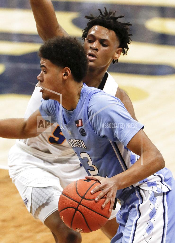 Keith Srakocic North Carolina's Cameron Johnson (13) drives past Pittsburgh's Au'Diese Toney (5) during the second half of an NCAA college basketball game, Saturday, Jan. 5, 2019, in Pittsburgh. North Carolina won 85-60. (AP Photo/Keith Srakocic)