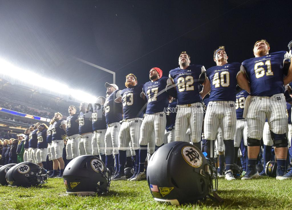 Howard Simmons Notre Dame players line up at the end zone to greet fans and cheer with them after an NCAA college football game against Syracuse, Saturday, Nov. 17, 2018, at Yankee Stadium in New York. (AP Photo/Howard Simmons)