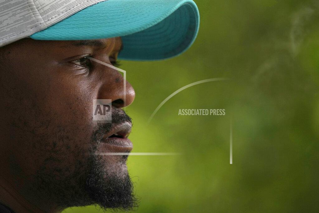 Alastair Grant Brian Flores Head Coach of the Miami Dolphins speaks to the press during a practice and media availability by the Miami Dolphins In Ware, England, Friday, Oct. 15, 2021. The Dolphins play the Jaguars in a regular season NFL game on Sunday at Tottenham Hotspurs White Hart Lane stadium in London. (AP Photo/Alastair Grant)