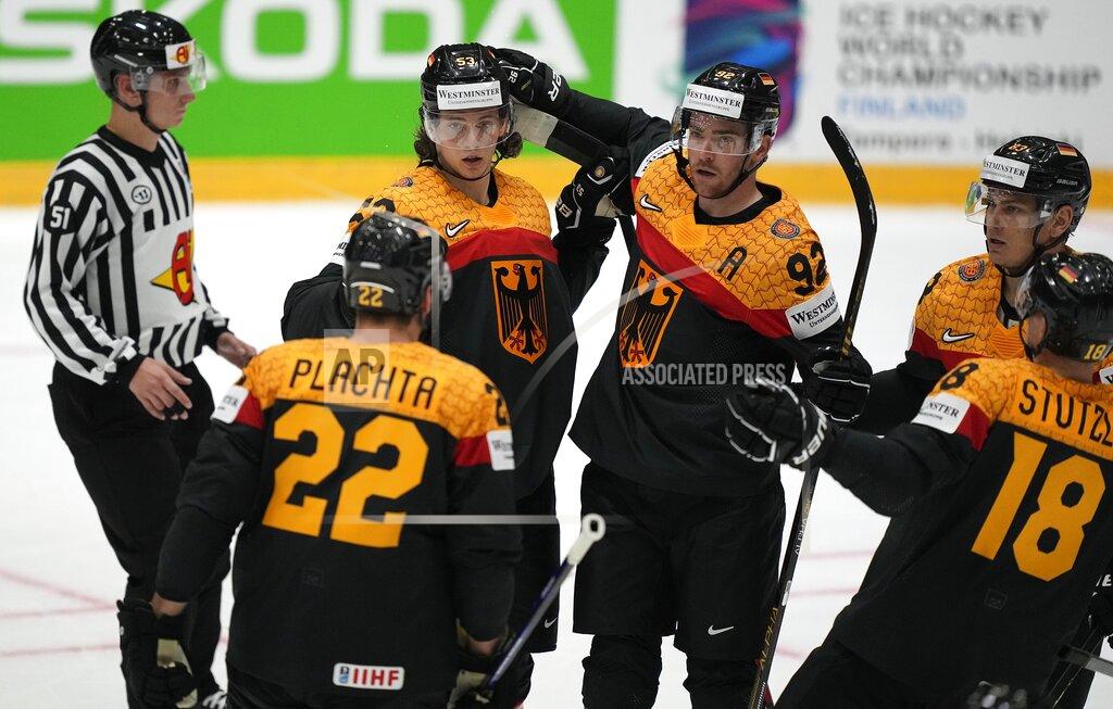 Martin Meissner Moritz Seider of Germany is is celebrated after scoring his side's third goal during the group A Hockey World Championship match between Germany and Canada in Helsinki, Finland, Friday May 13, 2022. (AP Photo/Martin Meissner)