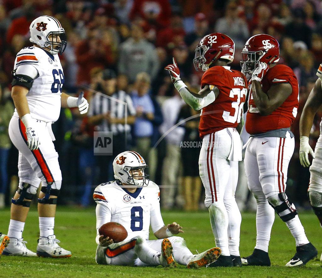 Butch Dill Auburn quarterback Jarrett Stidham (8) sits on the field after being sacked by Alabama linebacker Dylan Moses (32) during the second half of an NCAA college football game, Saturday, Nov. 24, 2018, in Tuscaloosa, Ala. (AP Photo/Butch Dill)