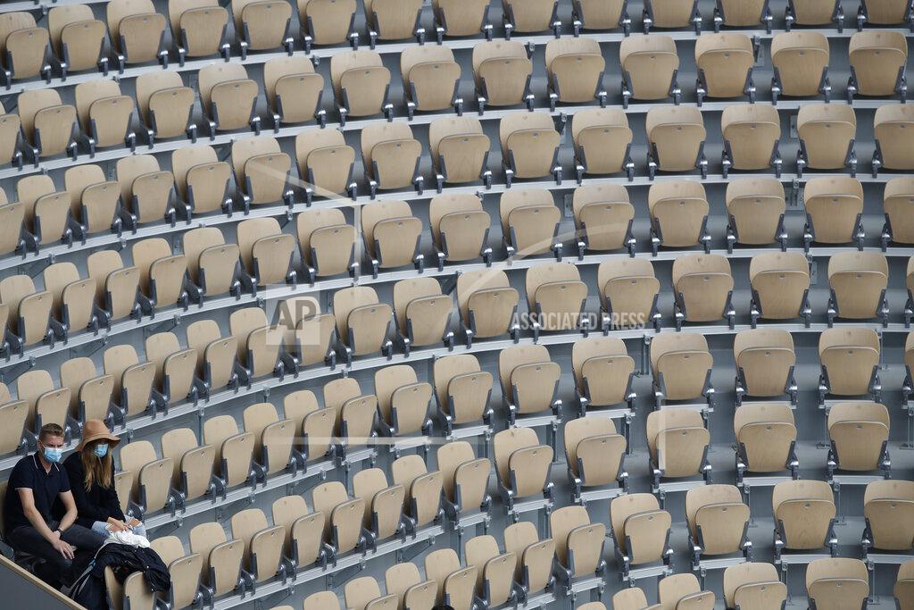 Alessandra Tarantino Two lone spectators at center court Philippe Chatrier watch Spain's Rafael Nadal and Argentina's Diego Schwartzman in the semifinal match of the French Open tennis tournament at the Roland Garros stadium in Paris, France, Friday, Oct. 9, 2020. (AP Photo/Alessandra Tarantino)