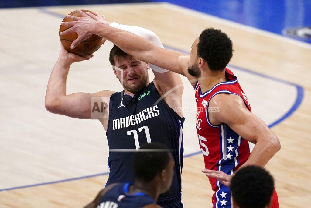 Tony Gutierrez Dallas Mavericks guard Luka Doncic (77) works to keep control of the ball against Philadelphia 76ers guard Ben Simmons (25) in the first half of an NBA basketball game in Dallas, Monday, April 12, 2021. (AP Photo/Tony Gutierrez)