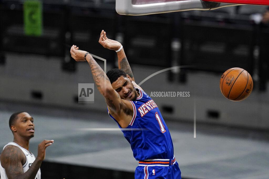 Eric Gay New York Knicks forward Obi Toppin (1) scores past San Antonio Spurs guard Lonnie Walker IV, left, during the second half of an NBA basketball game in San Antonio, Tuesday, March 2, 2021. (AP Photo/Eric Gay)