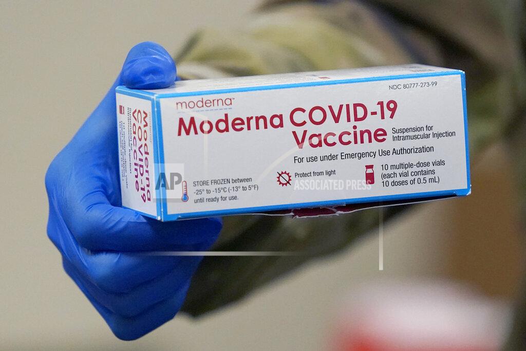 A member of the Mississippi National Guard shows the box that contained several vials of Moderna COVID-19 vaccine that were issued for use among Mississippi Air or Army National Guard service members who serve as first responders, Wednesday, Dec. 23, 2020, in Flowood, Miss. One hundred doses of the vaccine were administered to the service members who assist with the administering of the COVID-19 test at Mississippi Department of Health drive through community testing sites across the state. (AP Photo/Rogelio V. Solis)