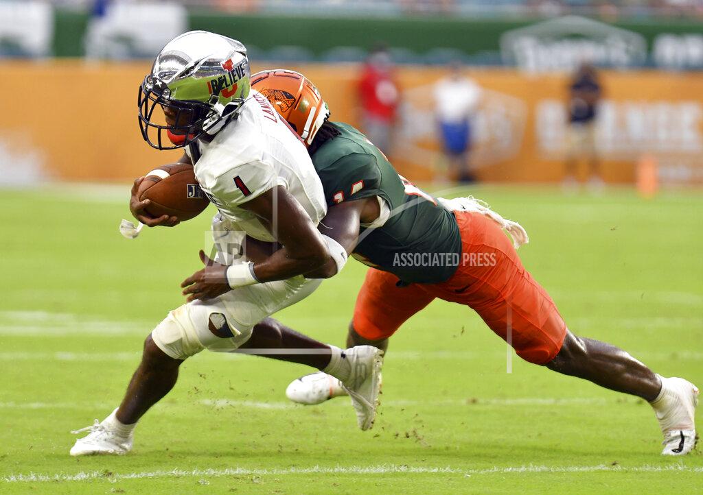 Jim Rassol Jackson State wide receiver Joshua Lanier (1) picks up a short gain as Florida A&M defensive back Trequan Butler, right, tackles him in the second quarter of an NCAA college football game, Sunday, Sept. 5, 2021, in Miami Gardens, Fla. (AP Photo/Jim Rassol)