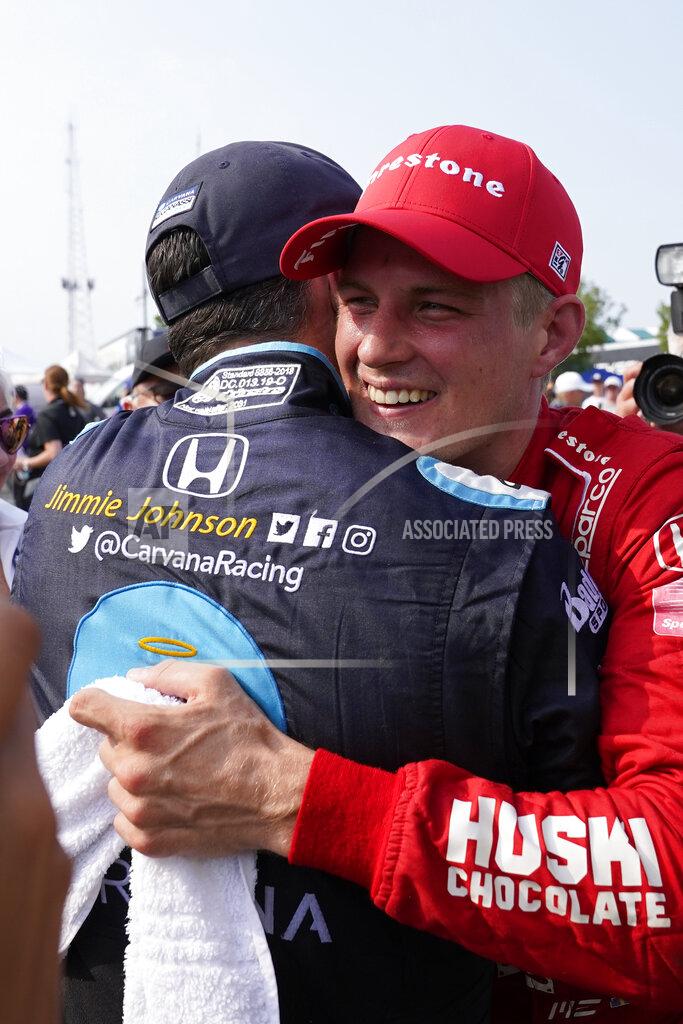 Paul Sancya Marcus Ericsson, of Sweden, celebrates with Jimmie Johnson after winning the first race of the IndyCar Detroit Grand Prix auto racing doubleheader on Belle Isle in Detroit, Saturday, June 12, 2021. (AP Photo/Paul Sancya)