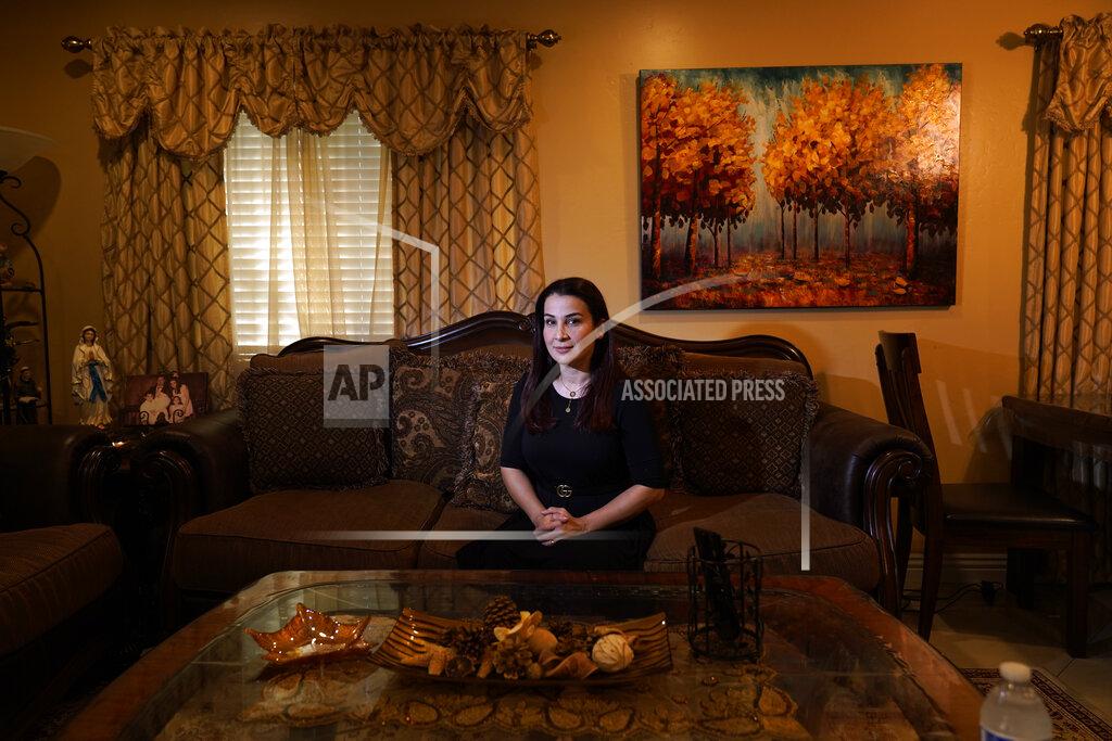 Iraqi immigrant Ethar Kakoz, a contact tracer for the COVID-19 virus, sits for a portrait Thursday, Oct. 22, 2020, in El Cajon, Calif. Kakoz is among a growing legion of ethnically and racially diverse contact tracers hired by local health departments to bridge the cultural divide in the United States and rebuild public confidence in America's public health system. (AP Photo/Gregory Bull)
