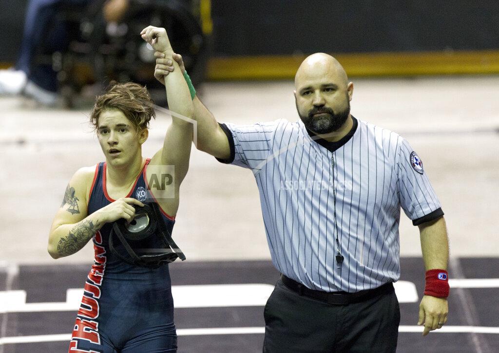 Jason Fochtman FILE - In this Saturday, Feb. 24, 2018 file photo, a referee raises the arm of Mack Beggs of Euless Trinity after he defeated Chelsea Sanchez of Morton Ranch to defend the Class 6A girls 110-pound title during the UIL State Wrestling Championships at the Berry Center in Cypress, Texas. Texas limits transgender athletes to teams conforming with the gender on their birth certificate. That law came under criticism in 2017 and 2018, when transgender male Beggs won state titles in girls’ wrestling competitions after he was told he could not compete as a boy. (Jason Fochtman/Houston Chronicle via AP)