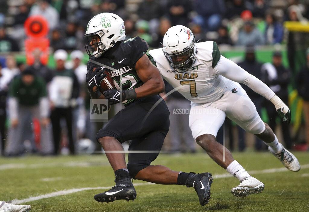 Sholten Singer Marshall running back Rasheen Ali (22) attempts to speed past UAB defender Tyler Taylor (7) during an NCAA college football game on Saturday, Nov. 13, 2021, at Joan C. Edwards Stadium in Huntington W.Va. (Sholten Singer/The Herald-Dispatch via AP)