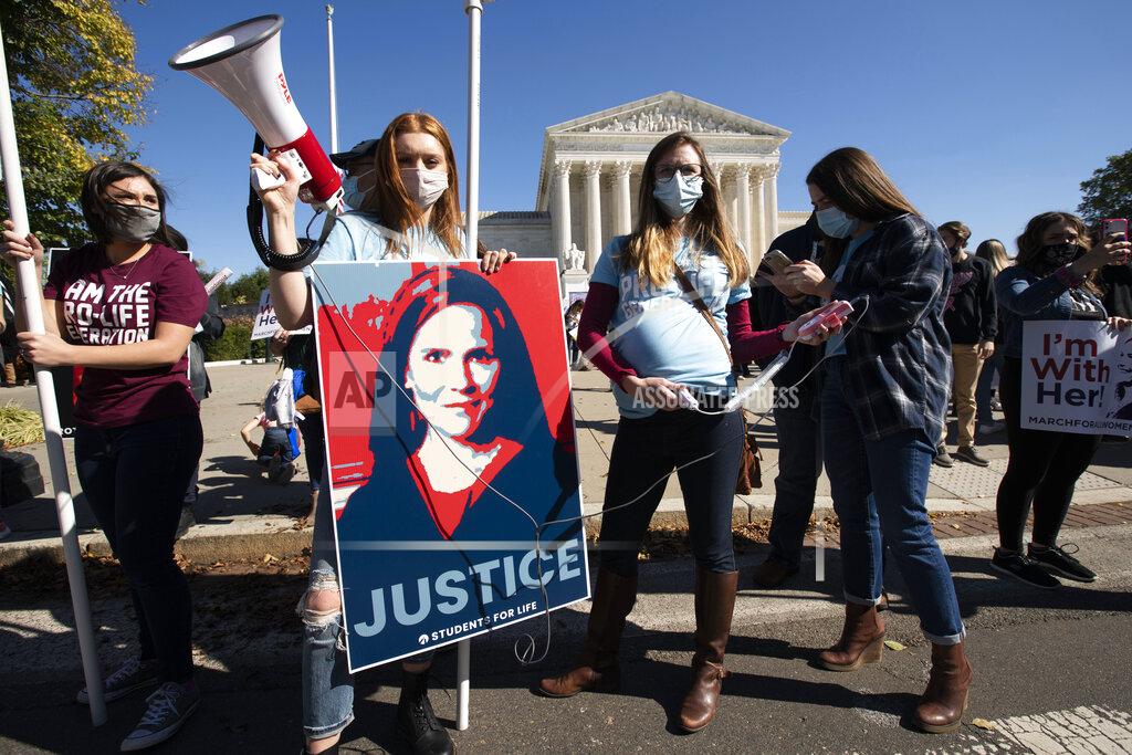 Jose Luis Magana Supporters of Supreme Court nominee Amy Coney Barrett rally outside the Supreme Court building during the Women's March in Washington, Saturday, Oct. 17, 2020. (AP Photo/Jose Luis Magana)