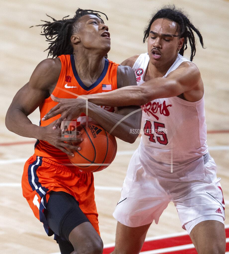 Francis Gardler Illinois' Ayo Dosunmu (11) is fouled by Nebraska guard Dalano Banton (45) during the first half of an NCAA college basketball game on Friday, Feb. 12, 2021, in Lincoln, Neb. (Francis Gardler/Lincoln Journal Star via AP)