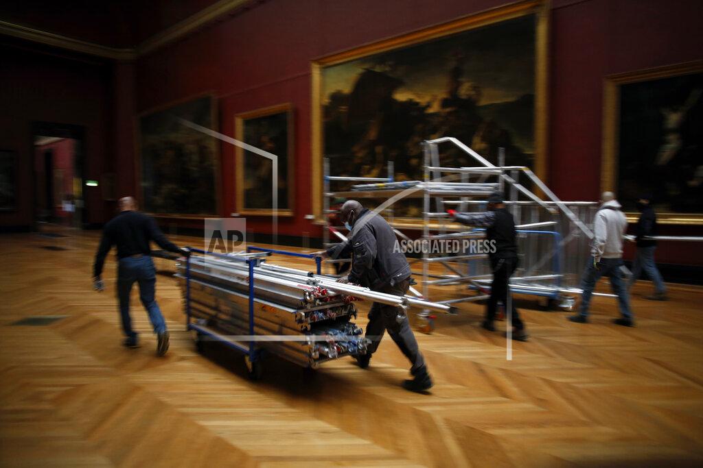 Thibault Camus Workers at the Louvre museum pull a scaffolding in Paris, Tuesday, Feb. 9, 2021. Though empty corridors and vacant galleries are a grim sight for frustrated art-lovers, they are a golden opportunity to do works of renovation, refurbishment and re-ordering that were simply not possible with the around 10 million visitors per year. (AP Photo/Thibault Camus)