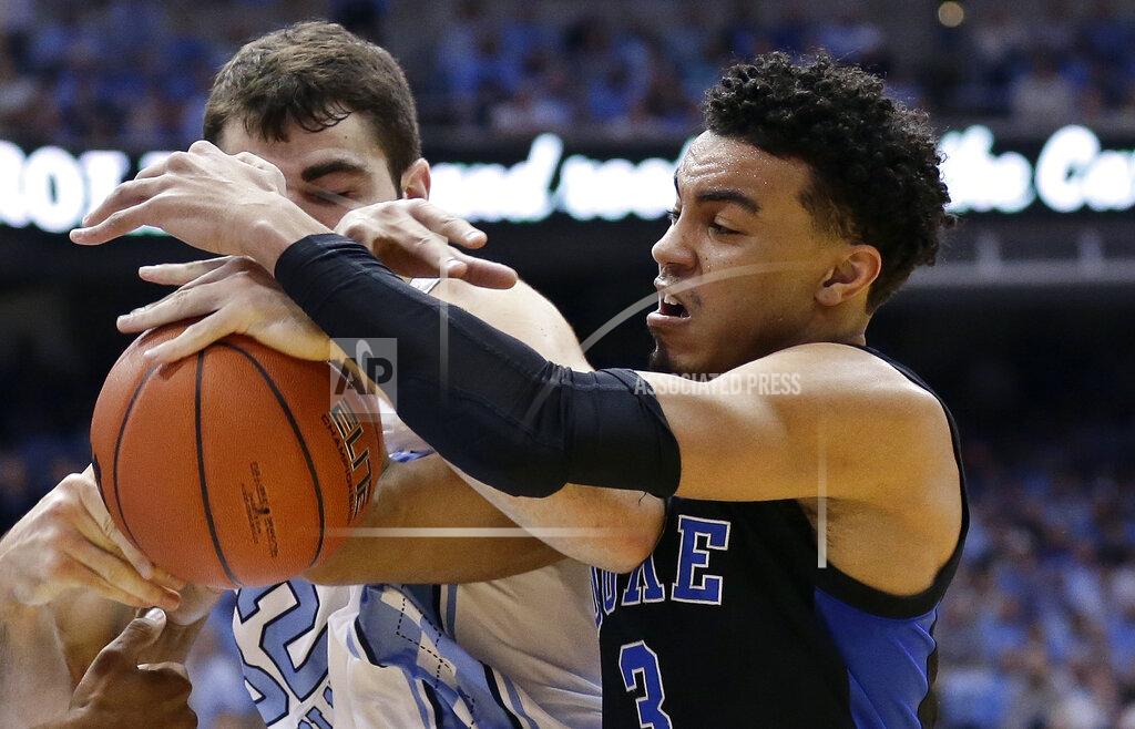 Gerry Broome North Carolina's Luke Maye, left, and Duke's Tre Jones (3) struggle for possession of the ball during the first half of an NCAA college basketball game in Chapel Hill, N.C., Saturday, March 9, 2019. (AP Photo/Gerry Broome)