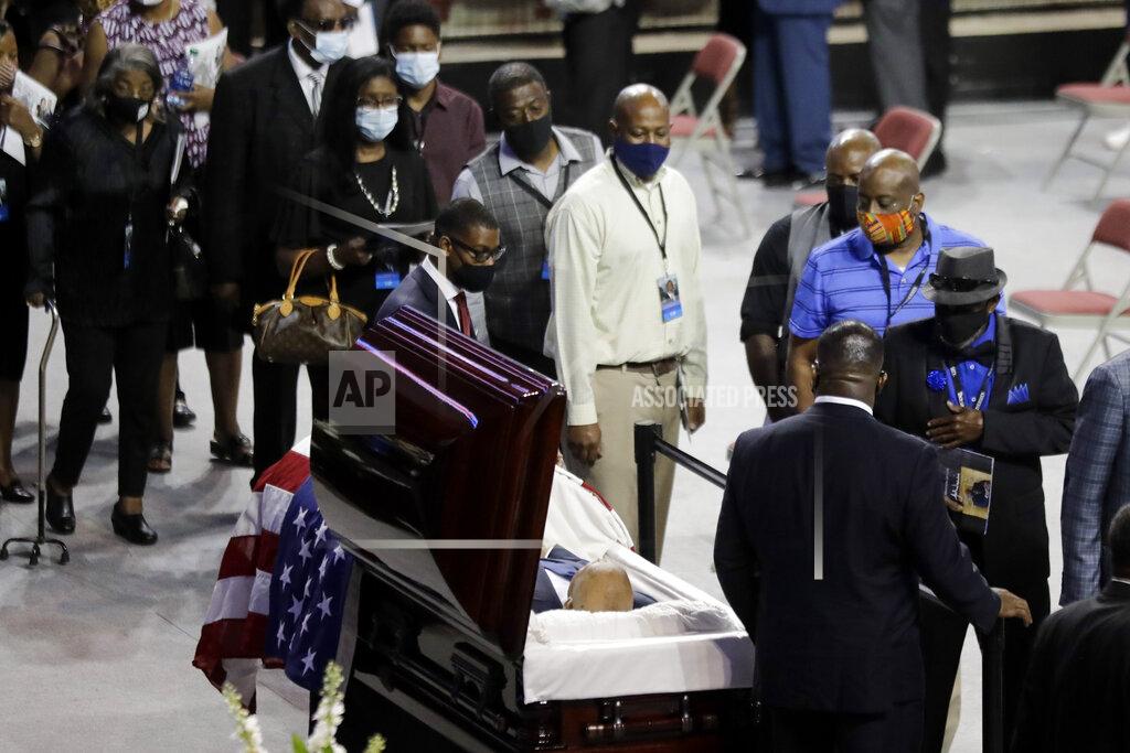 Brynn Anderson Mourners walk past the casket of the late Rep. John Lewis, D-Ga., during a service celebrating "The Boy from Troy" at Troy University on Saturday, July 25, 2020, in Troy, Ala. Lewis, who carried the struggle against racial discrimination from Southern battlegrounds of the 1960s to the halls of Congress, died Friday, July 17, 2020. (AP Photo/Brynn Anderson)