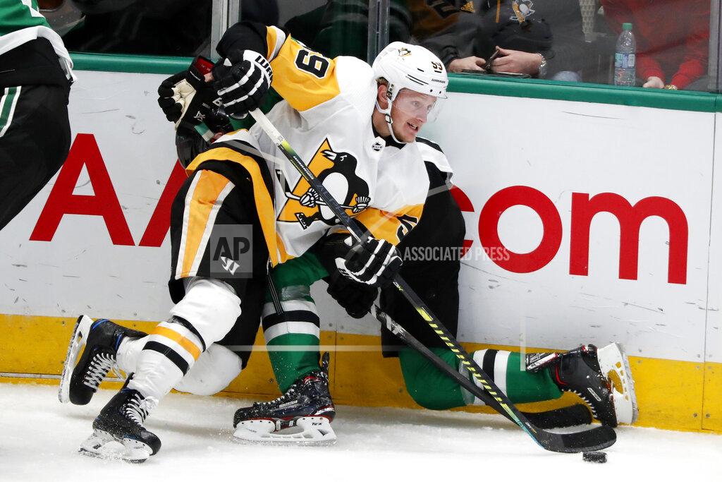 Tony Gutierrez FILE - In this Oct. 26, 2019, file photo, Pittsburgh Penguins' Jake Guentzel (59) checks Dallas Stars' Tyler Seguin, rear, against the boards as he gains control of the puck before making a pass in the third period of an NHL hockey game in Dallas. Guentzel feared his season was over thanks to a shoulder injury in December. The "pause" caused by the pandemic has given him renewed optimism that he will be ready when the playoffs hopefully being this summer. (AP Photo/Tony Gutierrez, File)