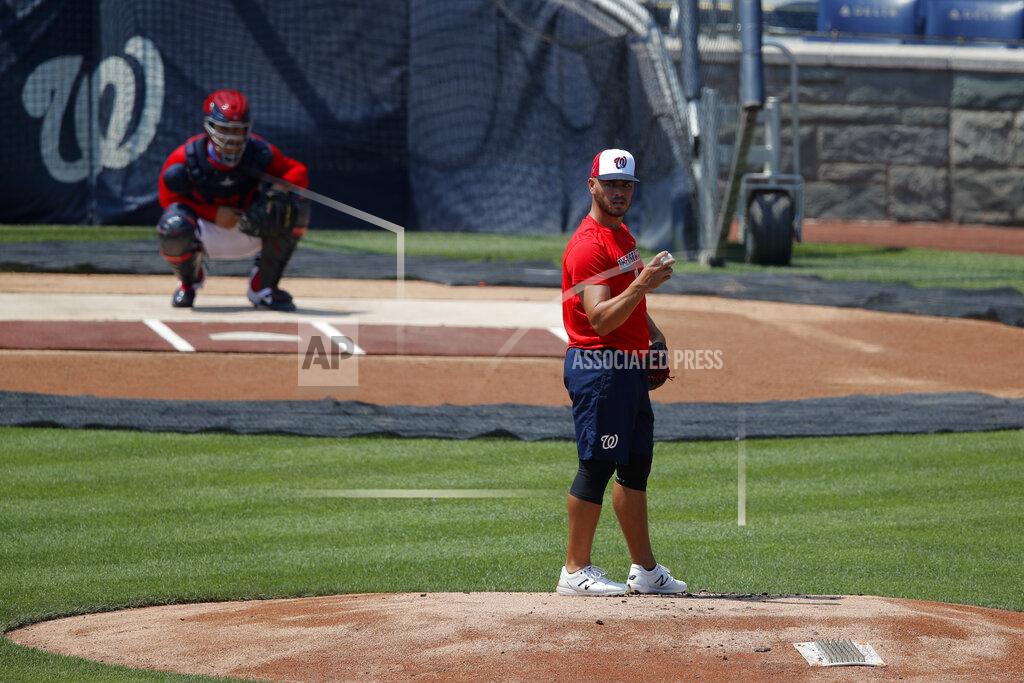 Carolyn Kaster Washington Nationals' pitcher Tanner Rainey, foreground, pauses on the mound during a baseball training camp workout at Nationals Stadium, Sunday, July 5, 2020, in Washington. (AP Photo/Carolyn Kaster)