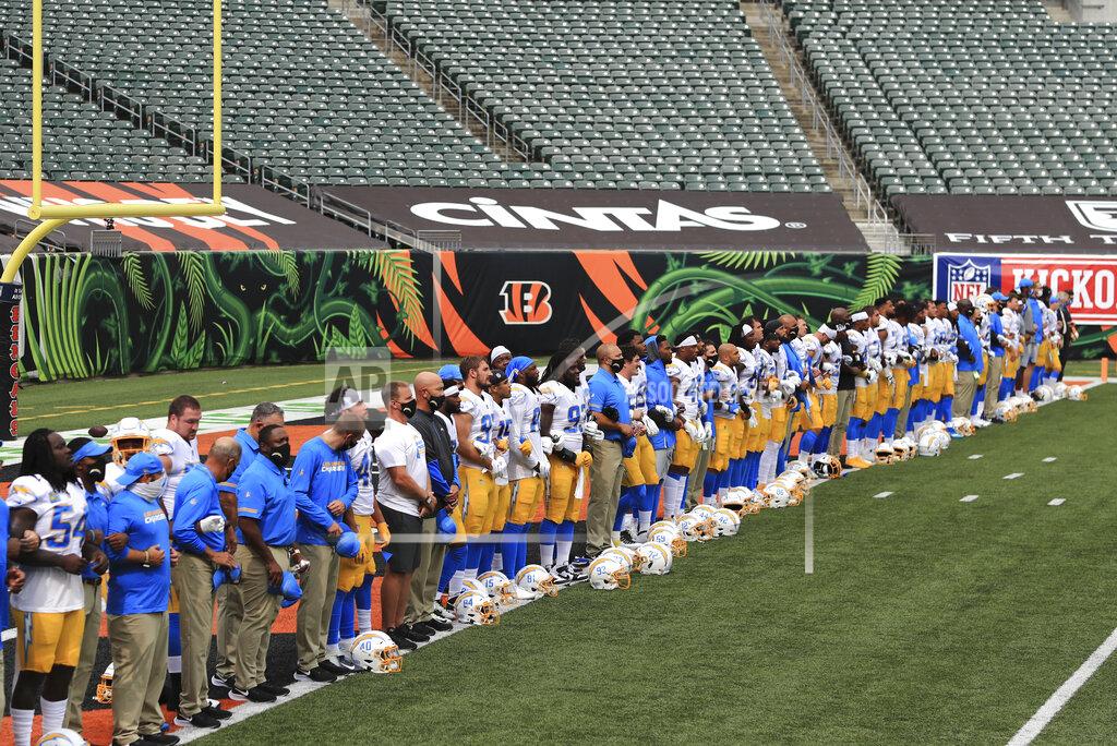 Aaron Doster The Los Angeles Chargers stand arm-in-arm as "Lift Every Voice and Sing" is played before an NFL football game against the Cincinnati Bengals, Sunday, Sept. 13, 2020, in Cincinnati. (AP Photo/Aaron Doster)