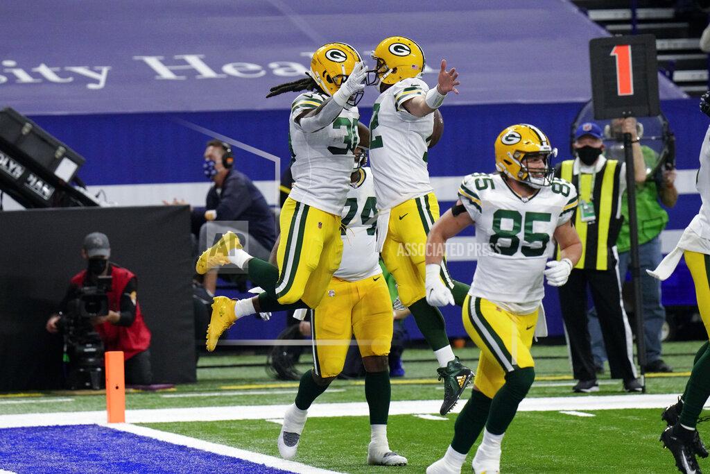 Aj Mast Green Bay Packers running back Jamaal Williams (30) and quarterback Aaron Rodgers (12) celebrate a touchdown during the first half of an NFL football game against the Indianapolis Colts, Sunday, Nov. 22, 2020, in Indianapolis. (AP Photo/AJ Mast)