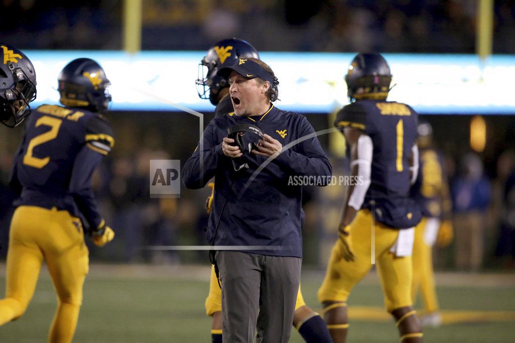 Ray Thompson West Virginia head coach Dana Holgorsen, center, shouts directions to his players during the first half of an NCAA college football game against Baylor, Thursday, Oct. 25, 2018, in Morgantown, W.Va. (AP Photo/Raymond Thompson)