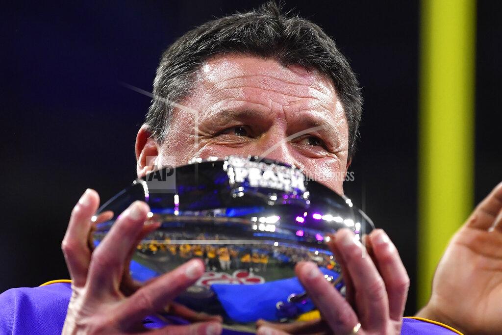John Amis LSU coach Ed Orgeron holds the trophy after the team's Peach Bowl NCAA semifinal college football playoff game against Oklahoma, Saturday, Dec. 28, 2019, in Atlanta. LSU won 63-28. (AP Photo/John Amis)