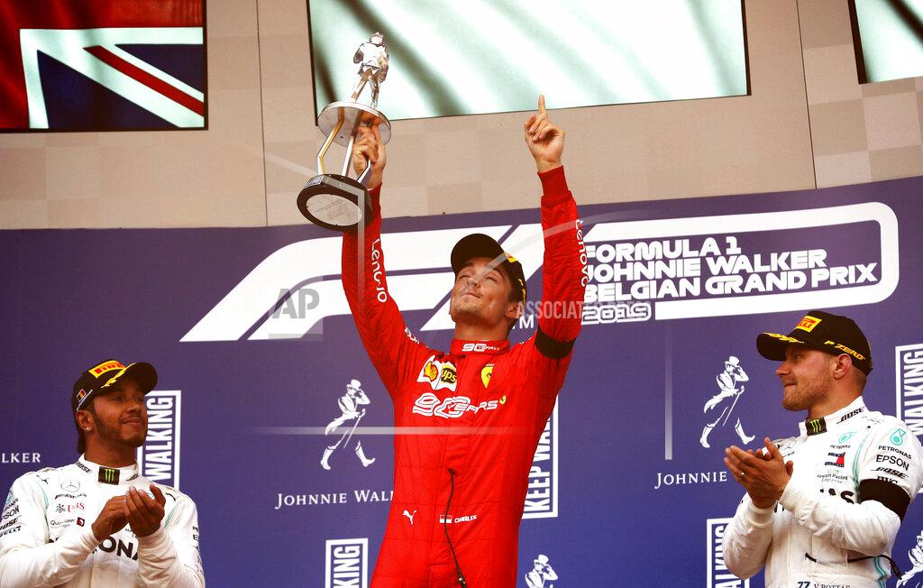 Francisco Seco Ferrari driver Charles Leclerc of Monaco, center, lifts the trophy after finishing first in the Belgian Formula One Grand Prix in Spa-Francorchamps, Belgium, Sunday, Sept. 1, 2019. Mercedes driver Lewis Hamilton of Britain, left, placed second and Mercedes driver Valtteri Bottas of Finland, right, placed third. (AP Photo/Francisco Seco)