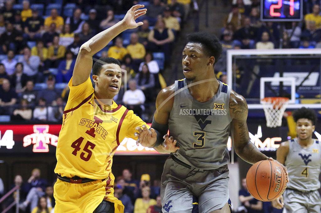 Kathleen Batten West Virginia forward Gabe Osabuohien (3) looks to pass the ball as he is defended by Iowa State guard Rasir Bolton (45) during the second half of an NCAA college basketball game Wednesday, Feb. 5, 2020, in Morgantown, W.Va. (AP Photo/Kathleen Batten)
