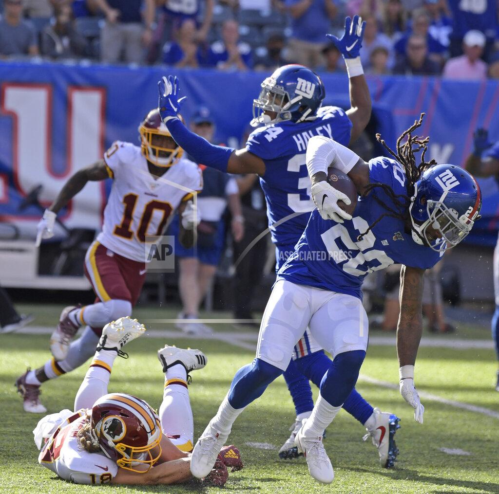 Bill Kostroun New York Giants cornerback Janoris Jenkins, right, runs with the ball after he intercepted it during the second half of an NFL football game against the Washington Redskins, Sunday, Sept. 29, 2019, in East Rutherford, N.J. (AP Photo/Bill Kostroun)