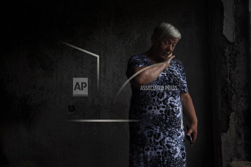 Nariman El-Mofty 64-year-old Tetiana Solohub, weeps as she stands in her apartment destroyed from Russian aerial bombs, in Borodyanka, Kyiv region, Ukraine, Tuesday, June 28, 2022. "And now, at 64, I am forced to be homeless," Solohub said. She doesn't have a damaged apartment to live in. Hers is completely gone. Solohub now lives in a camp made of shipping containers. (AP Photo/Nariman El-Mofty)