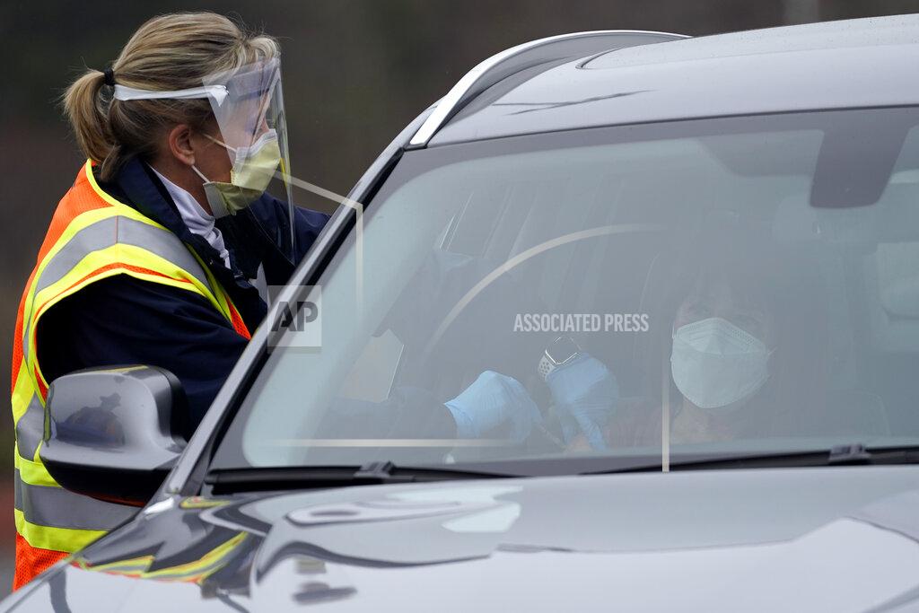 A healthcare worker administers the Pfizer COVID-19 vaccine Thursday, Feb. 11, 2021 at PNC Arena in Raleigh, N.C. Since North Carolina began administering the vaccine in December, more than 1 million people have gotten their first doses. (AP Photo/Gerry Broome)