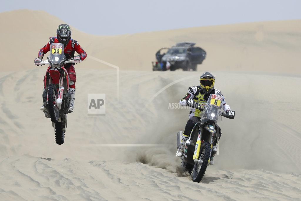 Ricardo Mazalan Ricky Brabec of United States, left, rides his Honda motorbike and Pablo Quintanilla of Chile rides his Husqvarna during the second stage of the Dakar Rally across the dunes between Pisco and San Juan de Marcona, Peru, Tuesday, Jan. 8, 2019. (AP Photo/Ricardo Mazalan)
