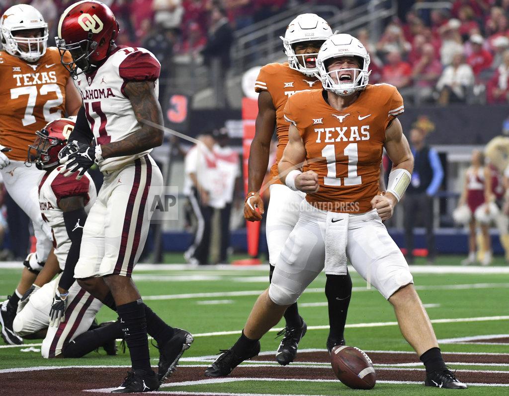 Jeffrey Mcwhorter Texas quarterback Sam Ehlinger (11) celebrates after scoring on a touchdown run against Oklahoma on the opening drive of the Big 12 Conference championship NCAA college football game on Saturday, Dec. 1, 2018, in Arlington, Texas. (AP Photo/Jeffrey McWhorter)