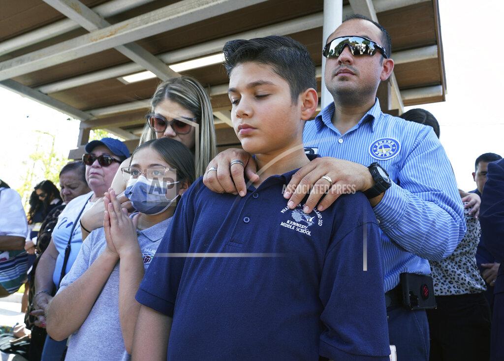 Joel Martinez Omahar Padillo holds on to his son Omahar Jr., 12, during a community prayer Wednesday, May 25, 2022, in Pharr, Texas, for the shooting victims at Robb Elementary School in Uvalde, Texas. (Joel Martinez/The Monitor via AP)