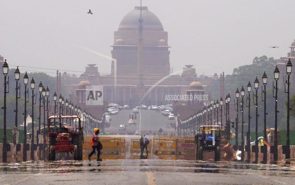 Manish Swarup A construction worker walks across a mirage created on a road following a heat weave, in New Delhi, Monday, May 2, 2022. The intense heat wave sweeping through South Asia was made more likely due to climate change and it is a sign of things to come. An analysis by international scientists said that this heat wave was made 30-times more likely because of climate change, and future warming would make heat waves more common and hotter in the future.(AP Photo/Manish Swarup)